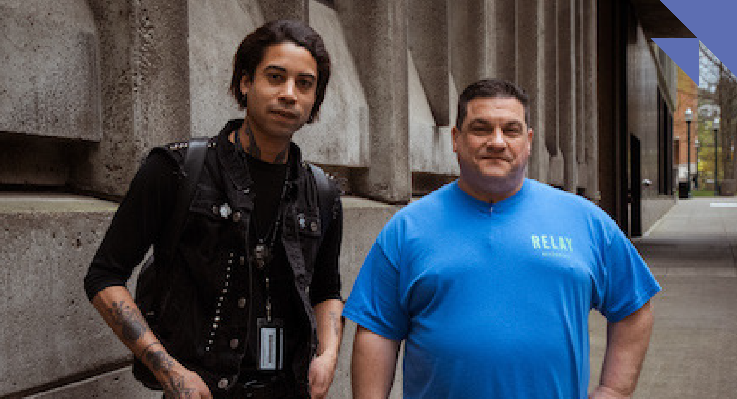 Two janitorial Relay workers, one in black, one in blue.