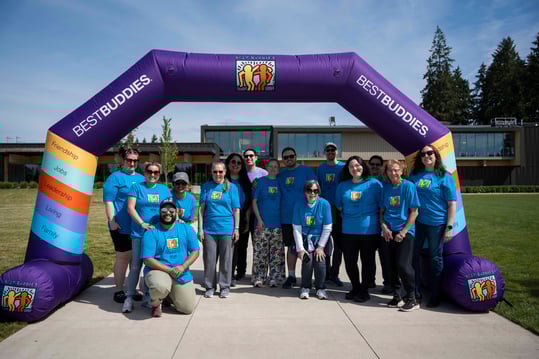 Relay team group photo under the Best Buddies arch