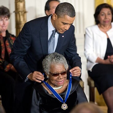 President Obama hangs a medal around Maya Angelou's neck 
