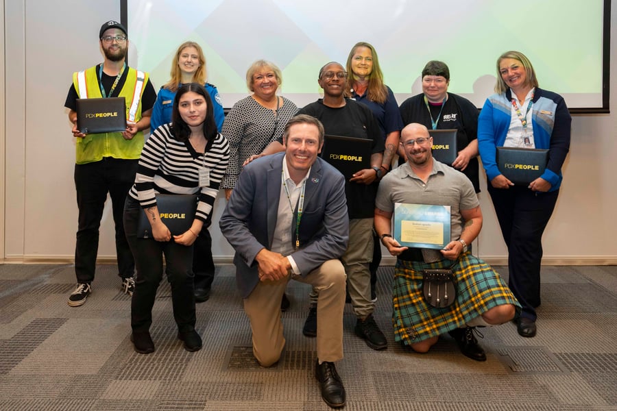 A group of people including two Relay Resources members pose for a photo with PDX People awards