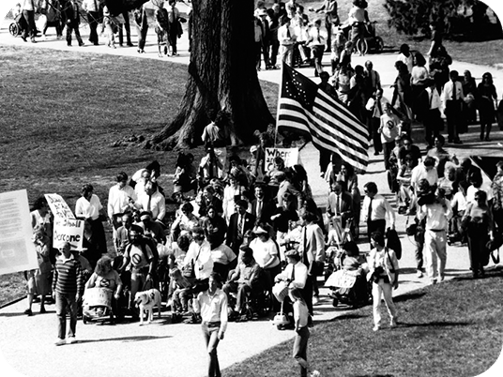 A stream of protestors make their way from the White House to the U.S. Capitol during the ADAPT-led protest on March 12, 1990. Photo by Tom Olin.