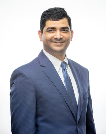 Suhail Khan Formal photo. He wears a blue suit with a blue tie. 