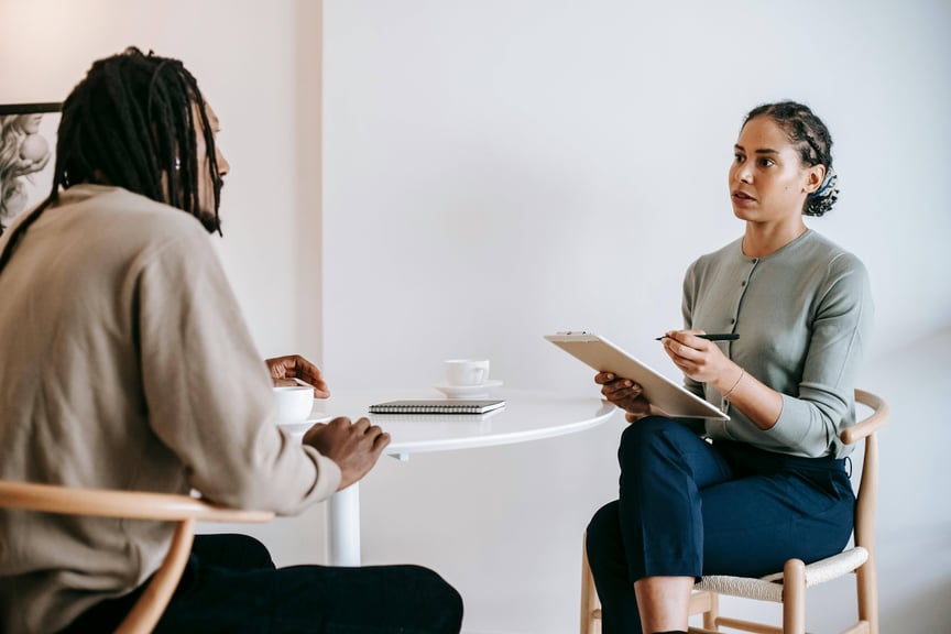 A black woman interviews a black man