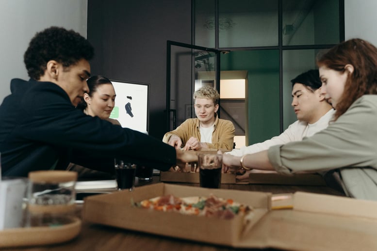 Employees share lunch during an office meeting