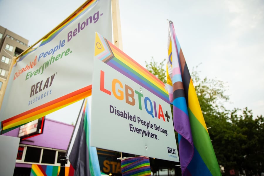 Pride flags that say "Disabled People Belong Everywhere."